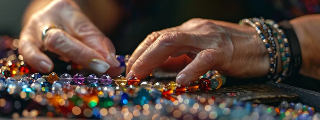 a jeweler arranging colorful gemstones on a bracelet.