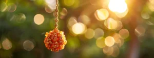 a close-up shot of a rare, pristine ten mukhi rudraksha hanging from a golden chain, glistening in the sunlight.