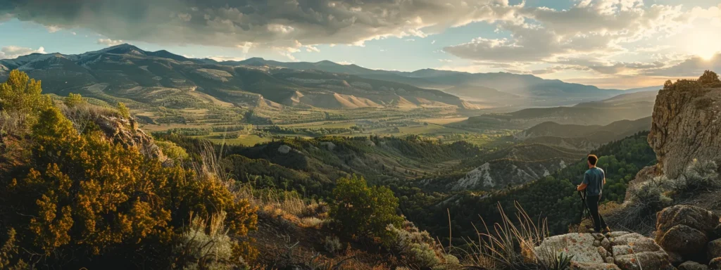 a man standing at the top of a mountain, overlooking a vast, lush valley filled with opportunities.