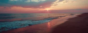 a serene beach at sunset with colorful sky and calm ocean, symbolizing inner peace and transformation from ptsd symptoms using psych-k techniques.